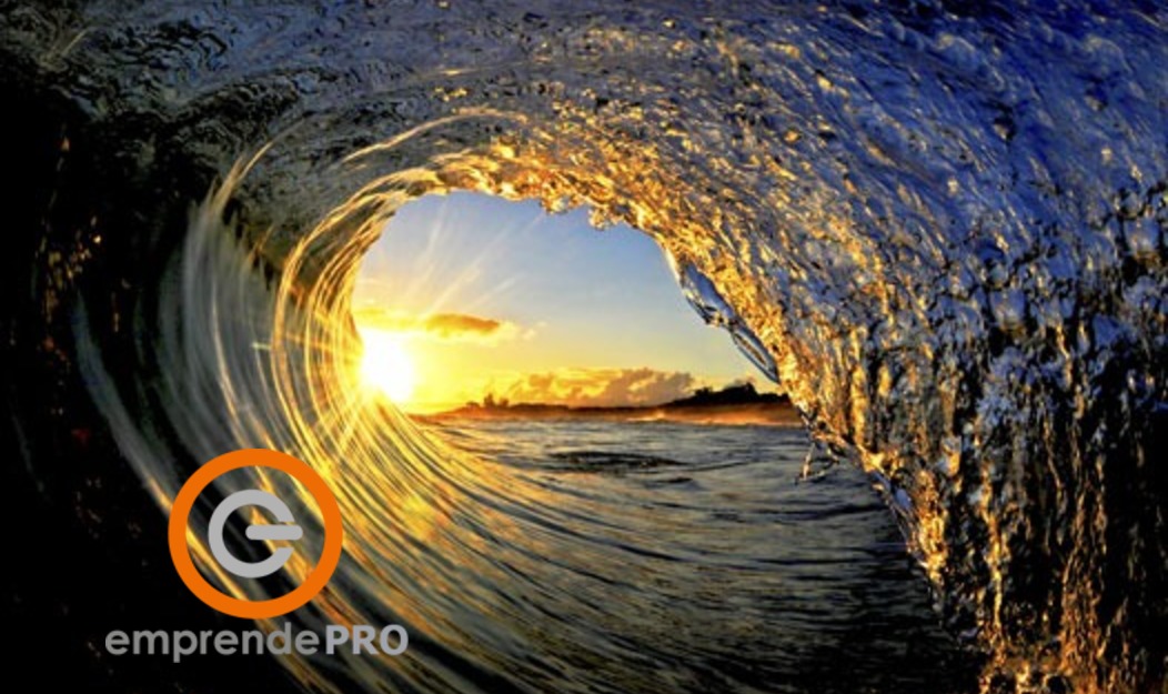 Logotipo de Emprende PRO sobre una ola de mar al atardecer